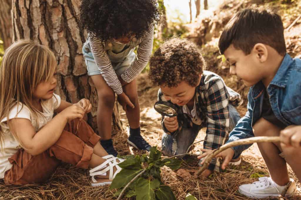 Funding For Outdoor Play In Canada Outdoor Play Canada   Kids Playing With Magnifying Glass In Woods 1024x683 